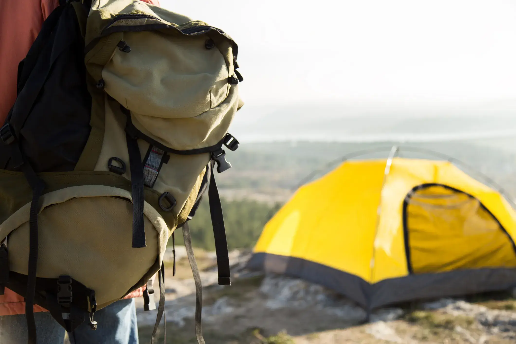 Person packing a backpack for an adventure.